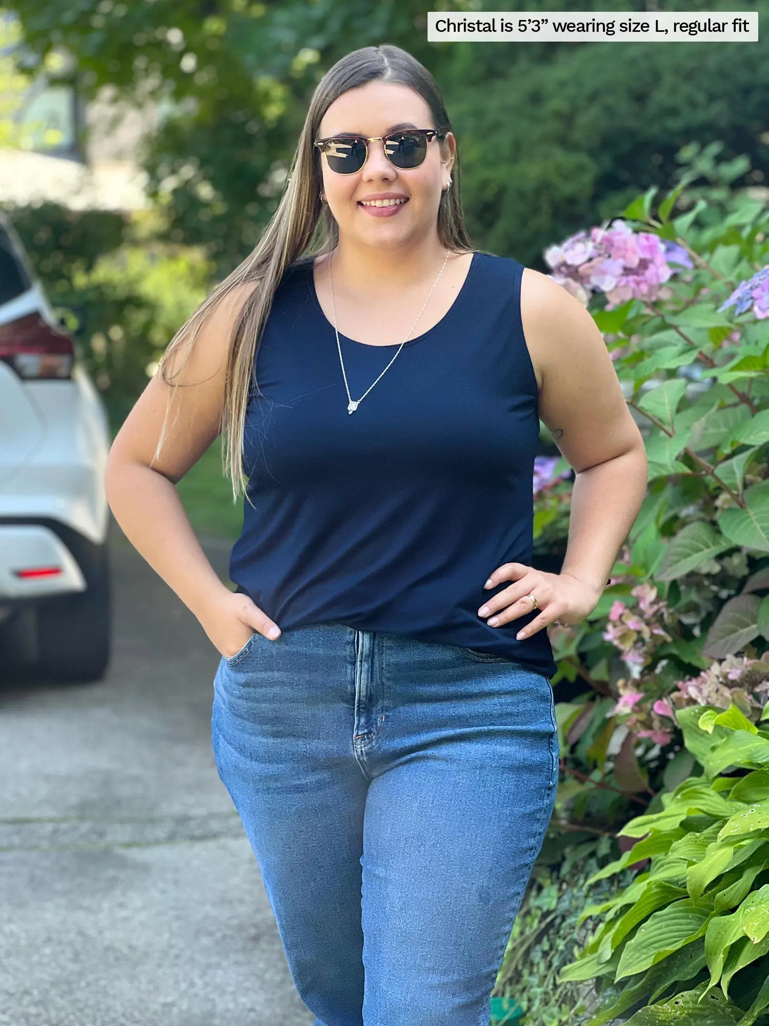 Miik model Christal (size L, five foot three) wearing Shandra reversible tank top in navy blue, with the scoop neck in front.
