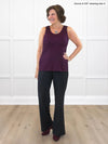 Miik founder Donna (5'6", small) smiling wearing Miik's Shandra reversible neckline tank top in port with a high waisted pant in black 
#color_port 