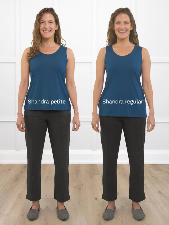 Miik model Lex (5'2", xsmall) smiling showing the difference of Miik's Shandra reversible tank top in petite and regular fit. Lex is wearing the Shandra tank in teal with a charcoal dress pant 
#color_teal