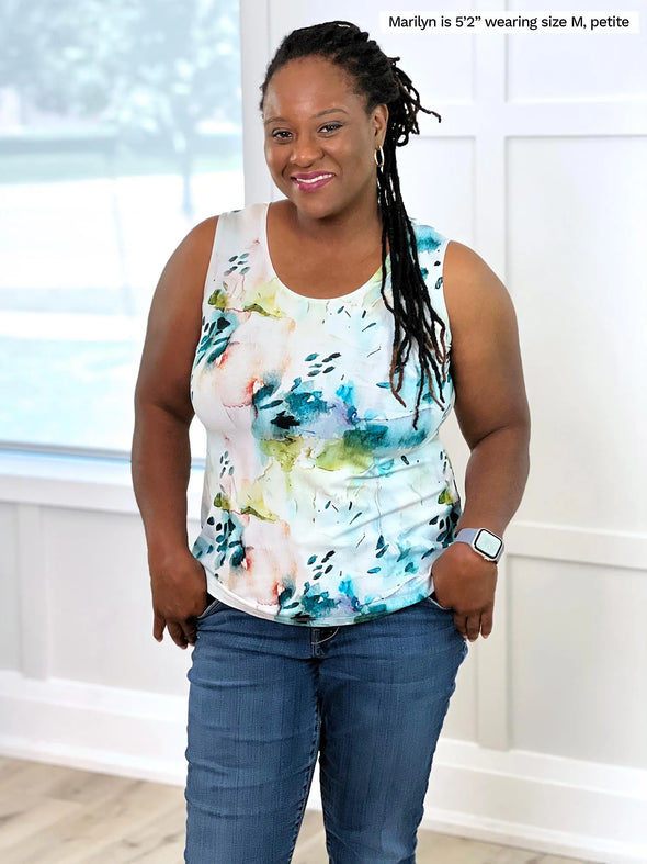 Miik model Marilyn (5'3", medium, petite) smiling wearing Miik's Shandra reversible tank top in water lily print in the petite fit with jeans 
#color_water-lily