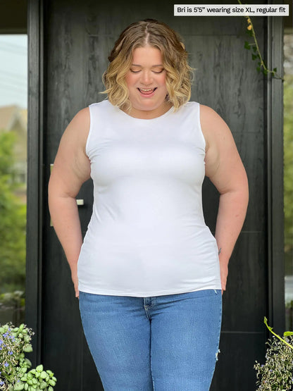 Miik model Bri (size XL, five foot five) wearing Shandra reversible tank top in white, reversed with the high neck in front.
