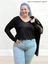 Miik model Kaitlin (size XL) wearing the Shannon long sleeve tee in black with jeans. #color_black