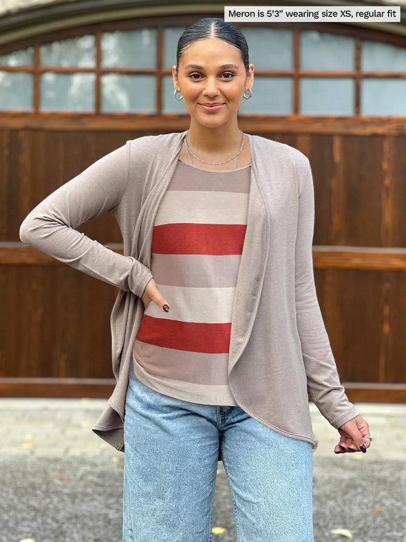 Miik model Meron (5'3", xsmall) wearing Miik's Shannon reversible neckline long sleeve tee in sedona stripe with a waterfall cardigan in mushroom melange and jeans #color_sedona-stripe