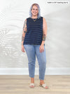 Miik model Kaitlin (5'9", xxlarge) smiling wearing Miik's Shyanne reversible neckline side slit tank in navy pinstripe with jeans #color_navy-pinstripe 