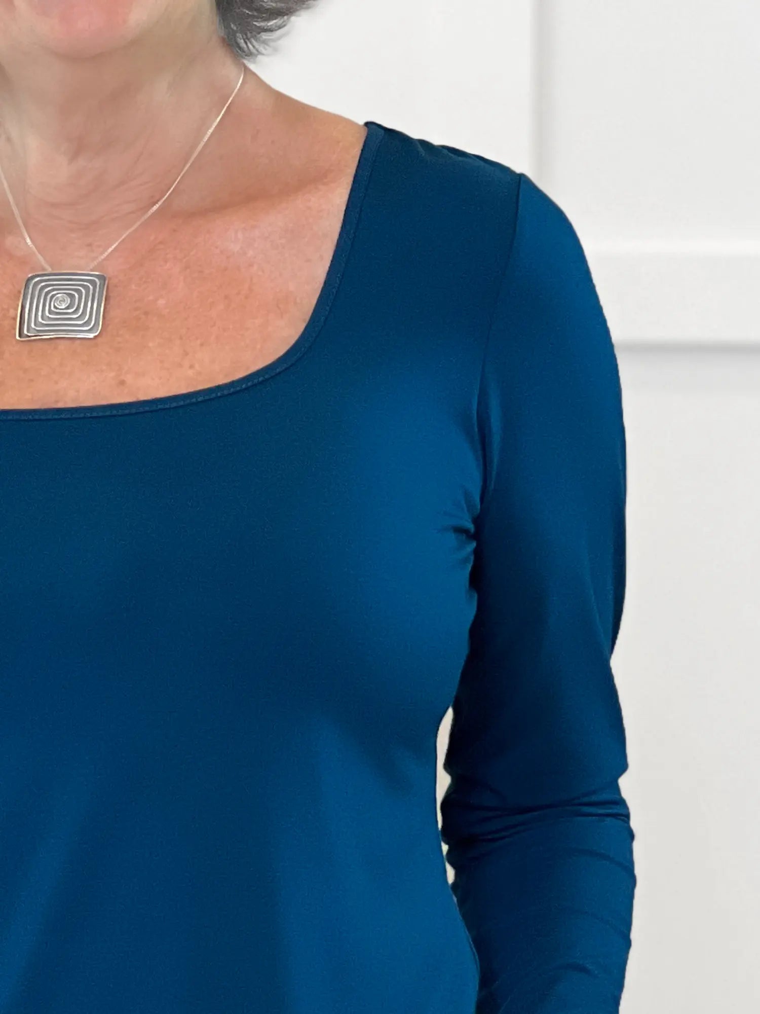 A close up image of the square neckline of Miik&