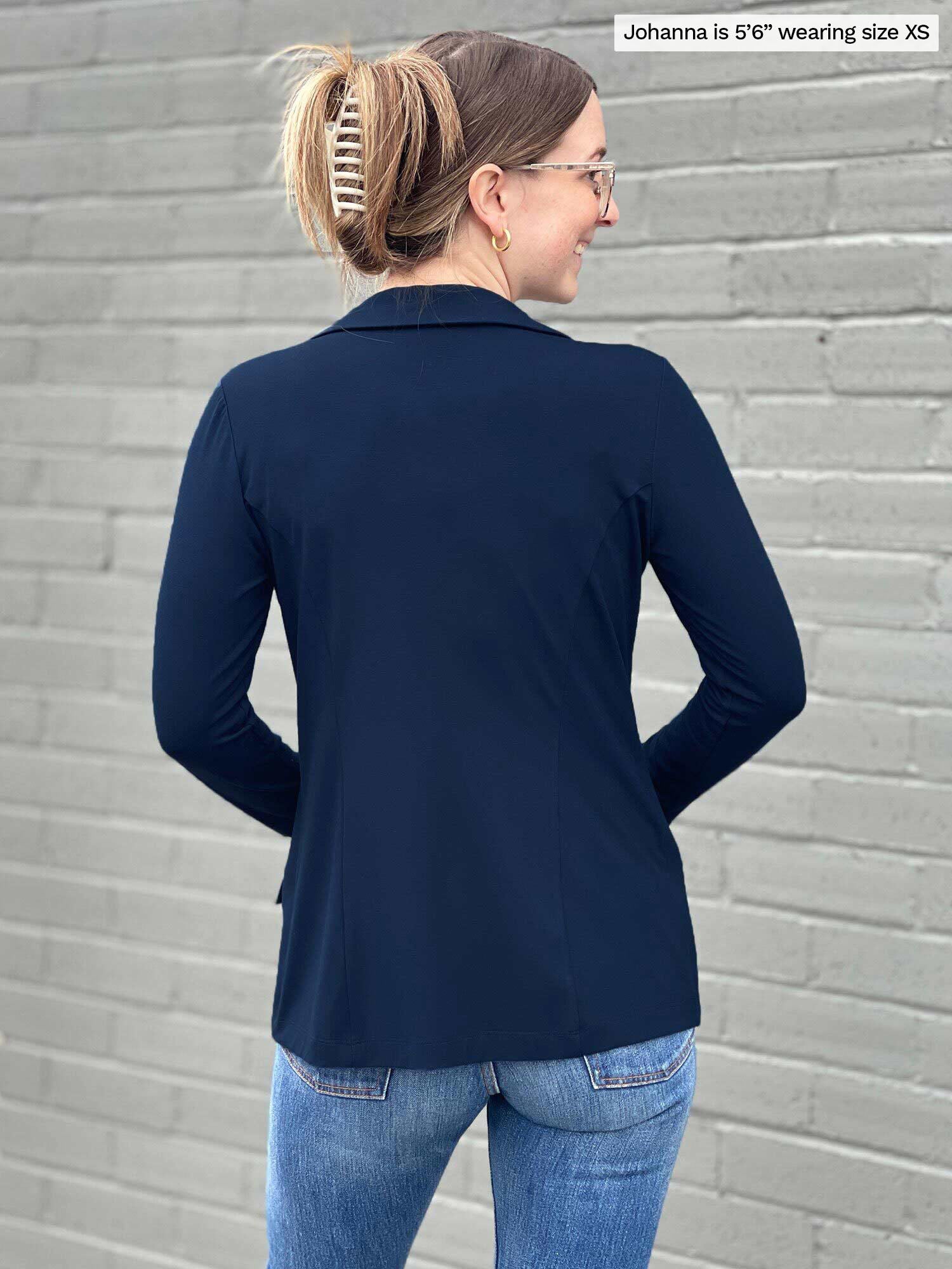 Miik model Johanna (five feet six, size extra small) standing with her back towards the camera showing the back of Miik&