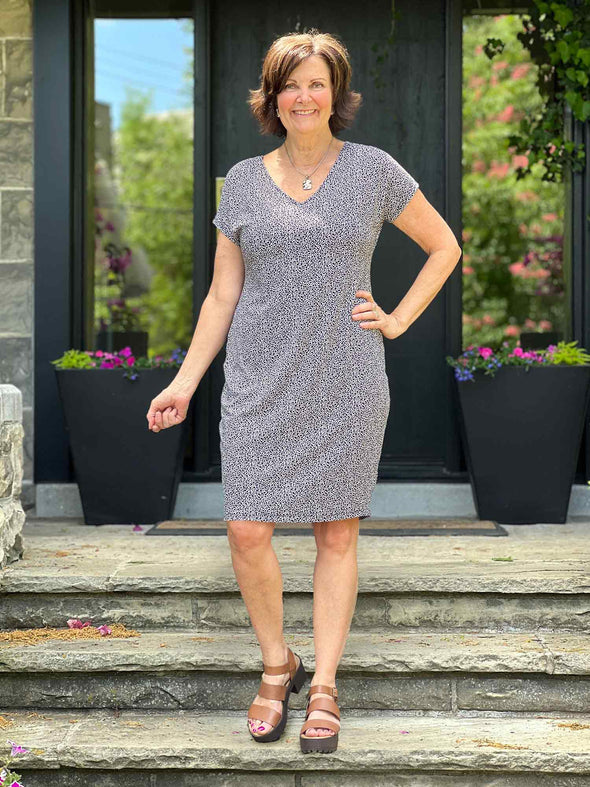 Miik founder Donna (5'6", small) smiling wearing Miik's Sofia reversible everyday dress in pebble print with sandals