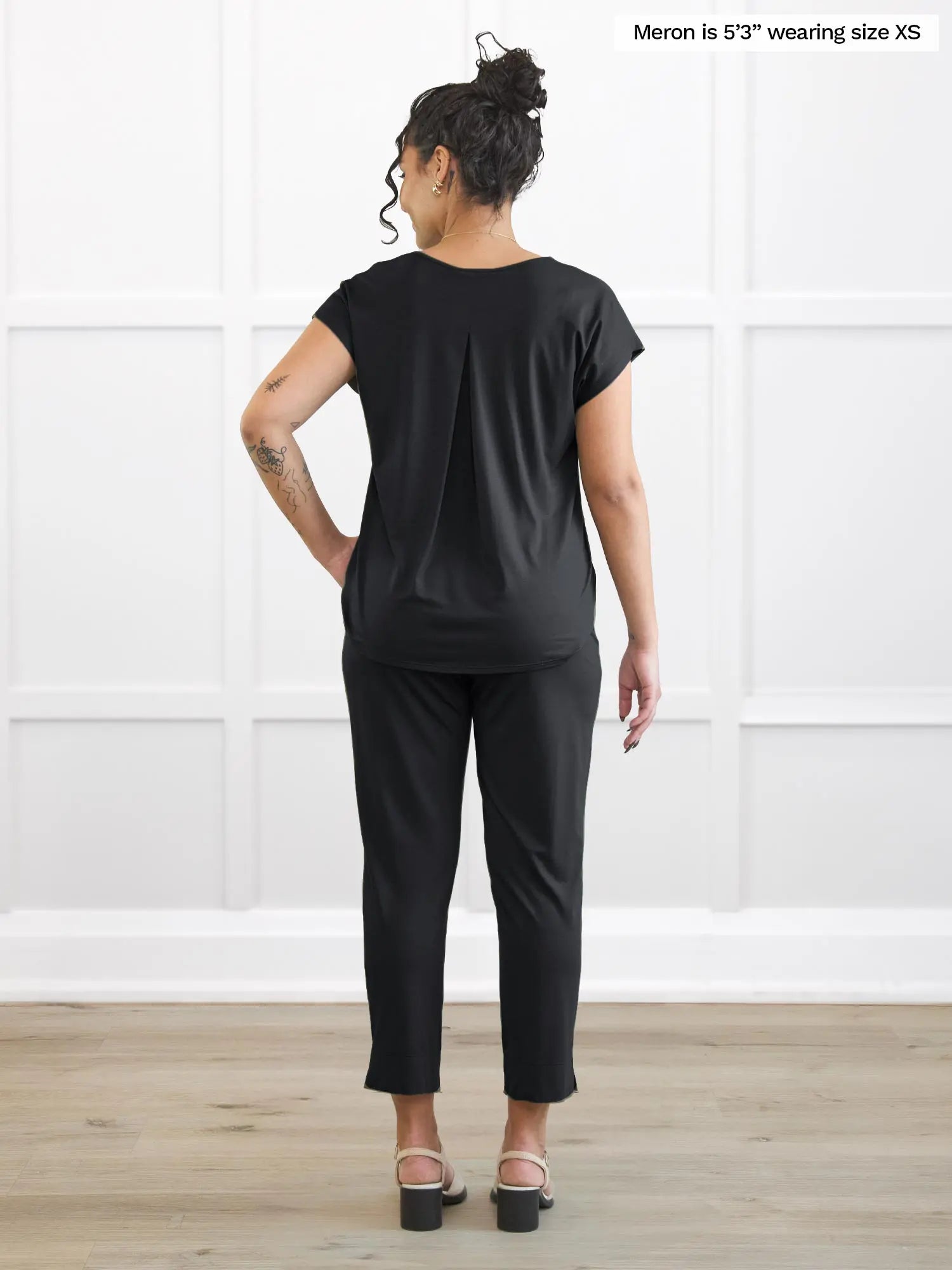 Miik model Meron (5’3”, xsmall) standing with her back towards the camera showing the back of Miik&