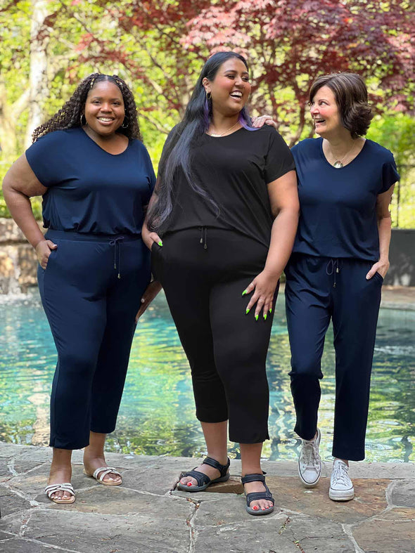 Miik models plus size Kimesha and Sureka along with founder Donna smiling all wearing Miik's Stef v-neck open-back capri jumpsuit