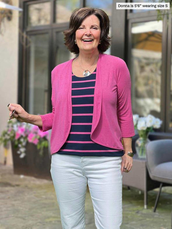 Miik founder Donna (5'6", small) smiling wearing Miik's Wesley cropped cardigan in pretty in pink with a striped tank and white jeans 