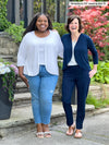 Miik founder Donna and model Kimesha standing next to each other both laughing wearing Miik's Wesley cropped cardigan. Erica is wearing in white with a tank in the same colour and jeans while Donna is wearing in navy with a matching dress pant colour and white tank 