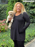 Miik model Carley (five feet two, xxlarge) smiling while holding a puppy wearing  Miik&